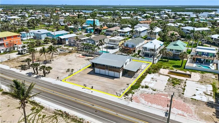 Aerial perspective of suburban area with property parcel outlined- Virtually Enhanced