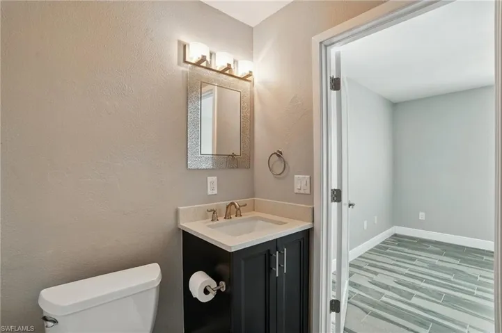 Half bath with toilet and vanity- Virtually Enhanced