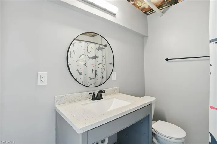 Full bath with vanity and curtained shower- Virtually Enhanced