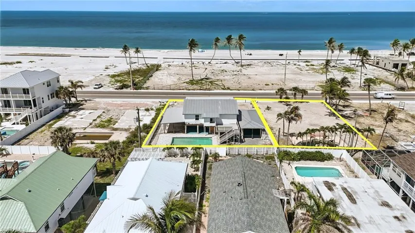 Aerial view of property and surrounding area with a pool area and property parcel outlined neighboring lot can be included in bundle or separately purchased- Virtually Enhanced