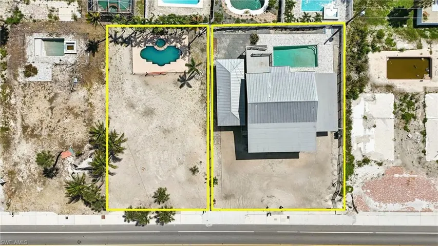 Aerial view of property and surrounding area with property parcel outlined neighboring lot can be included in bundle or separately purchased- Virtually Enhanced