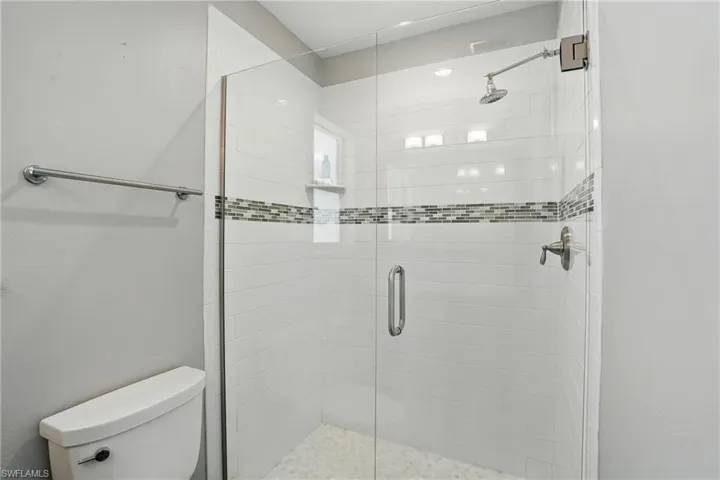 Full bathroom with toilet and a shower stall- Virtually Enhanced