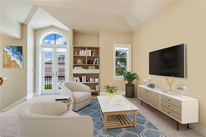 Carpeted living room featuring vaulted ceiling