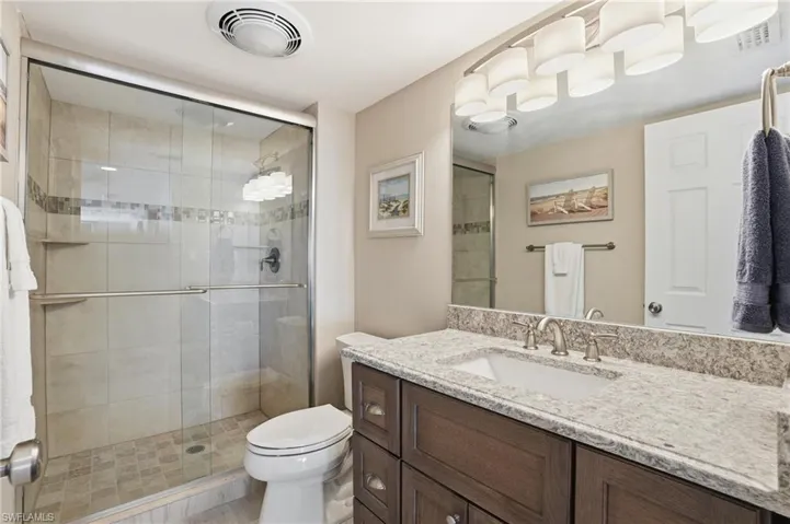 Full bath featuring a shower stall and vanity - Virtually Edited Image