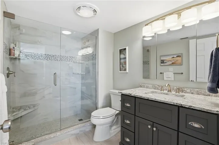 Bathroom featuring vanity and a shower stall - Virtually Edited Image