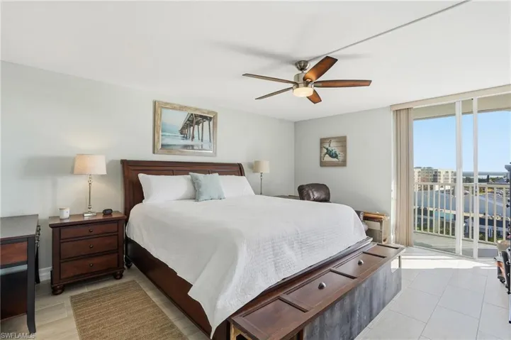 Bedroom with access to exterior, ceiling fan, floor to ceiling windows, and light tile patterned flooring - Virtually Edited Image
