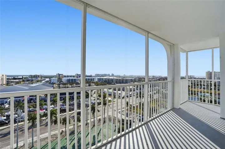 Balcony featuring a sunroom and a city view - Virtually Edited Image