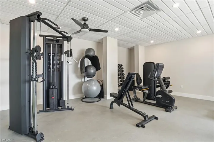 Exercise area with ceiling fan and recessed lighting - Virtually Edited Image