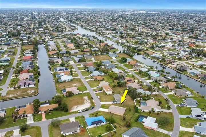 Birds eye view of property with a water view