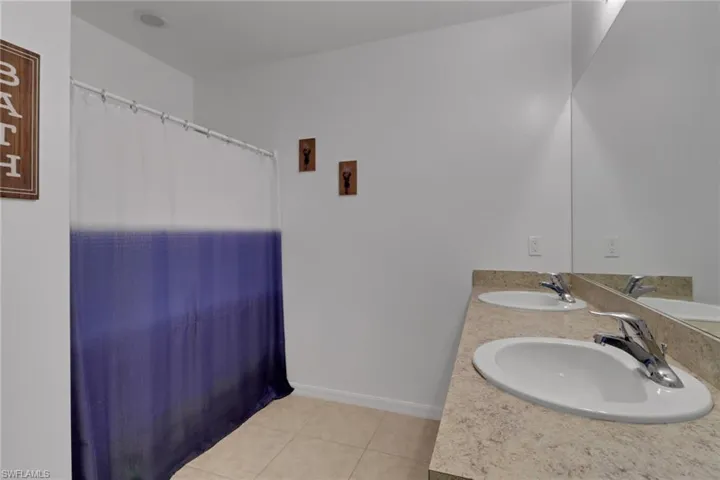 Bathroom featuring vanity and tile patterned floors