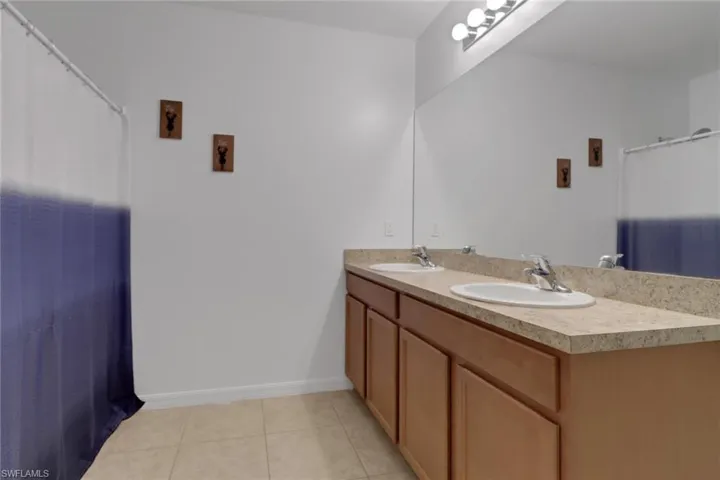 Bathroom with tile patterned floors and vanity