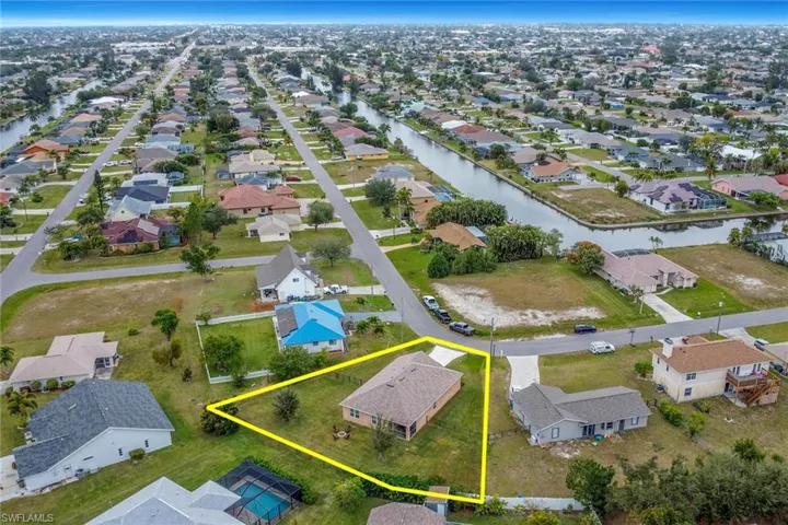 Birds eye view of property with a water view