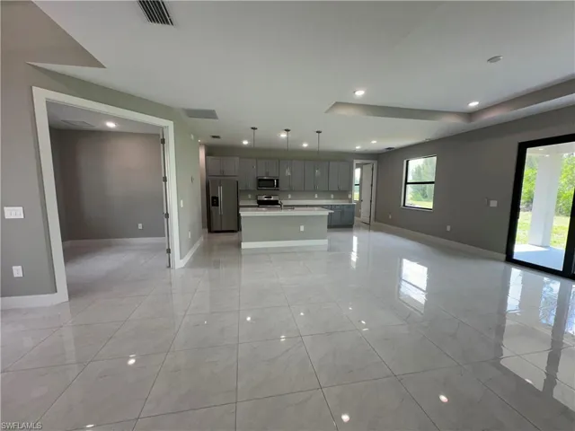 Unfurnished living room featuring light tile patterned floors