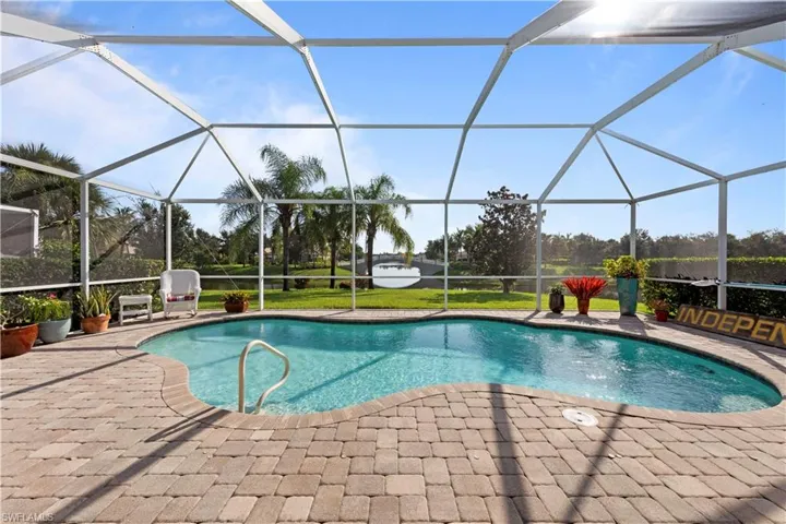 Swimming pool featuring a patio area and glass enclosure