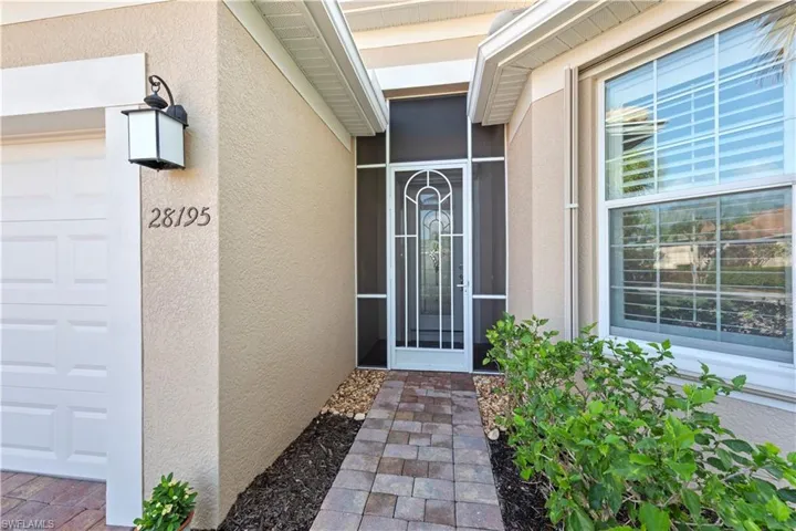 Doorway to property with stucco siding and a garage