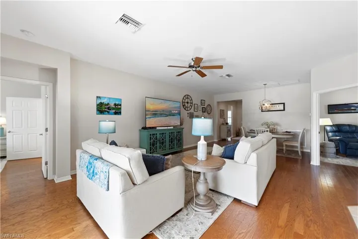 Living room with wood finished floors and ceiling fan