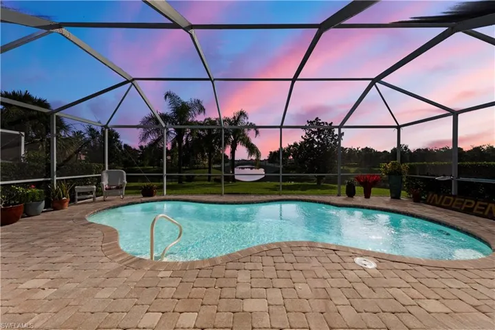 Morning sun over pool, patio, an outdoor pool, and glass enclosure