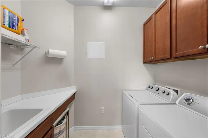 Laundry area featuring cabinet space and washer and clothes dryer