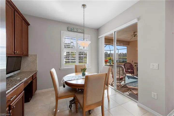 Dining room with a ceiling fan and light tile patterned floors