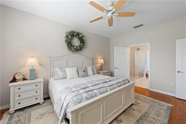 Bedroom with light wood-style floors and a ceiling fan