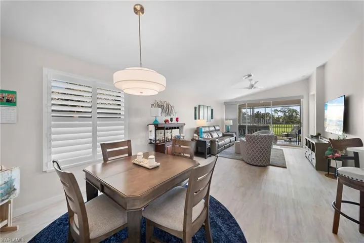Dining room featuring lofted ceiling, light wood-style flooring, and ceiling fan