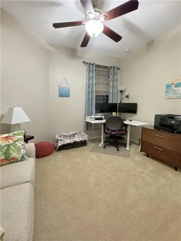 Carpeted home office or 3rdd bedroom with ceiling fan