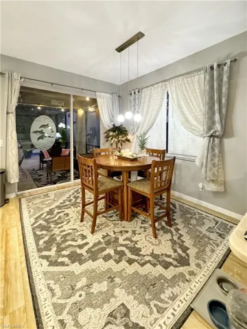 Dining space featuring wood-type flooring and a chandelier
