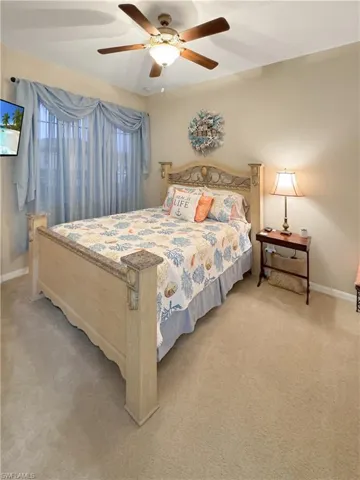 Carpeted 2nd bedroom featuring ceiling fan