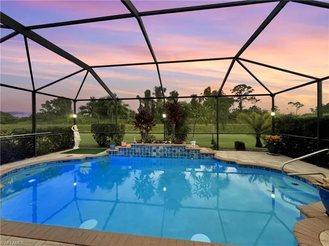 Pool at dusk with partial florida glass for privacy
