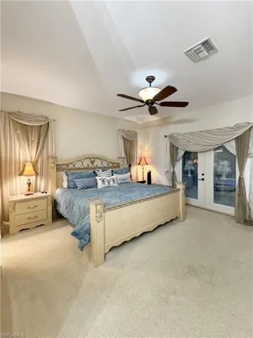 Large primary bedroom with 9' ceiling and french doors to pool/patio area