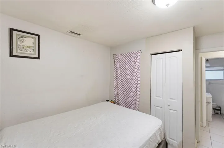 Bedroom with a closet and a textured ceiling