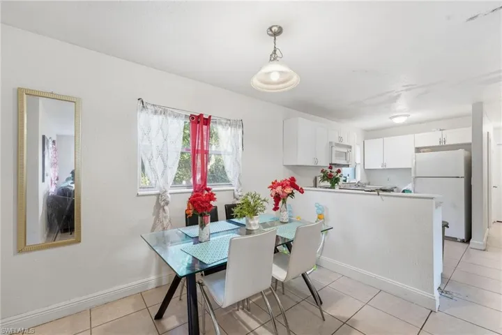Dining room with light tile patterned flooring and baseboards