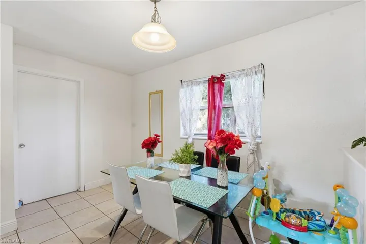Dining area featuring light tile patterned floors and baseboards