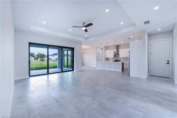 Unfurnished living room featuring ceiling fan and recessed lighting