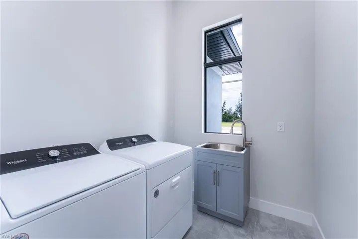 Laundry room featuring washer and dryer and plenty of natural light