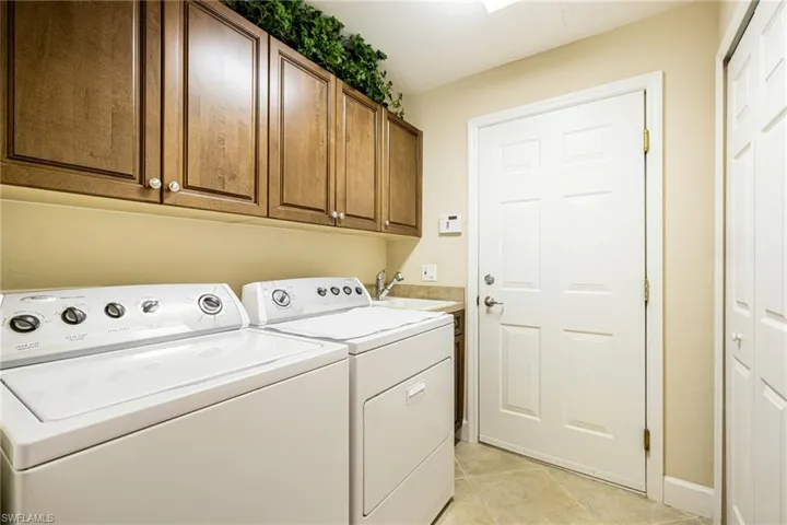 Laundry with utility sink and cabinets