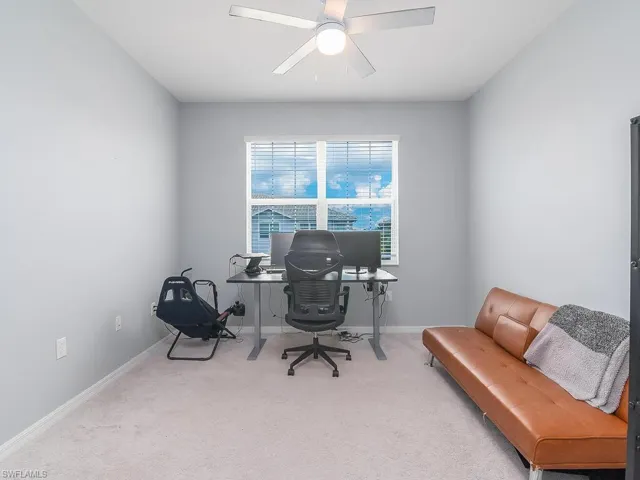 Carpeted office space with ceiling fan