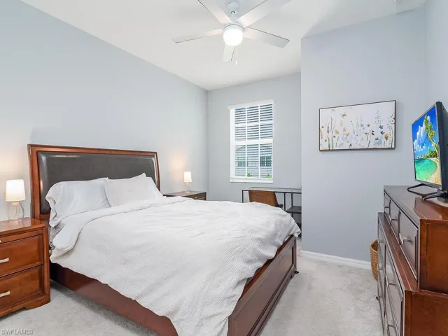 Bedroom with light carpet and ceiling fan