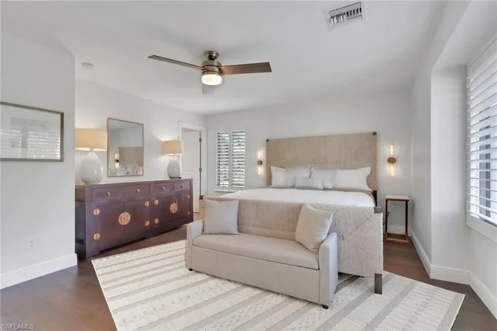 Bedroom featuring a ceiling fan and dark wood-type flooring
