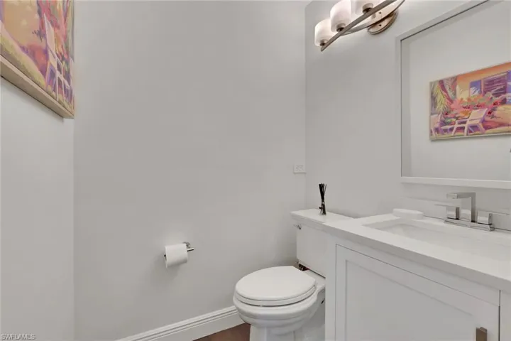 Bathroom featuring vanity and dark wood-style flooring