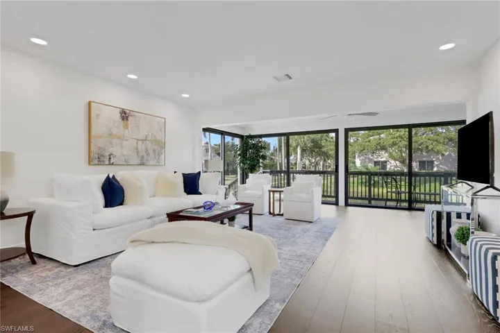 Living area featuring hardwood / wood-style floors and recessed lighting