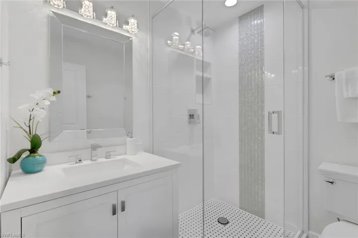 Full bathroom with a shower stall and vanity