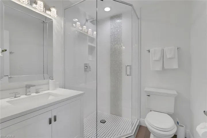 Bathroom with vanity and a stall shower