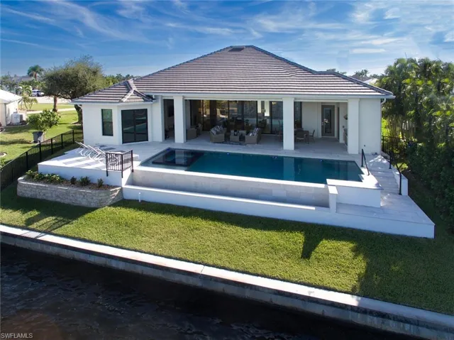 Back of house with a tiled roof, a fenced backyard, a patio area, and stucco siding