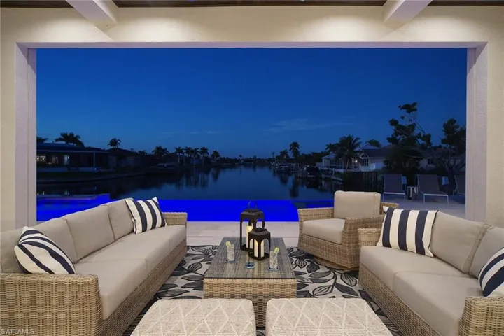 View of patio / terrace with outdoor lounge area, a water view, and an outdoor pool