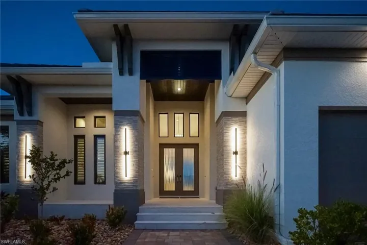 View of exterior entry featuring stucco siding