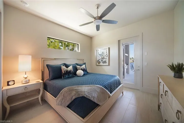Bedroom with access to exterior, ceiling fan, and light wood-style flooring