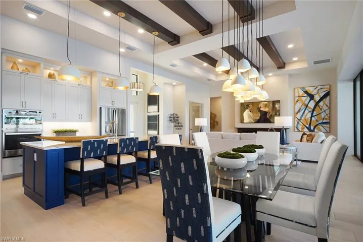 Dining space with light wood-style flooring, beam ceiling, and recessed lighting