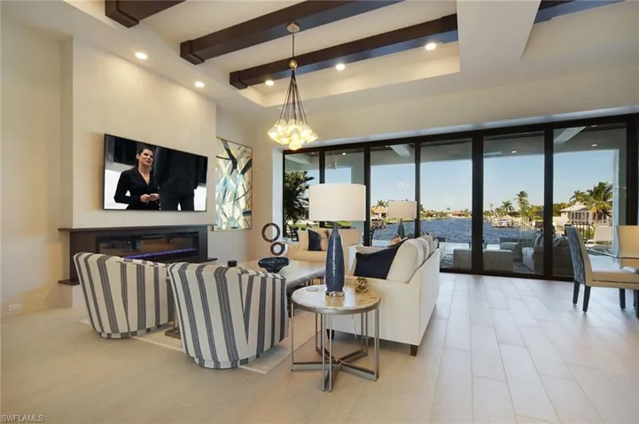 Living area featuring beamed ceiling and recessed lighting