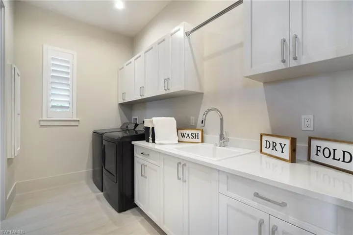 Laundry area with washing machine and clothes dryer and cabinet space